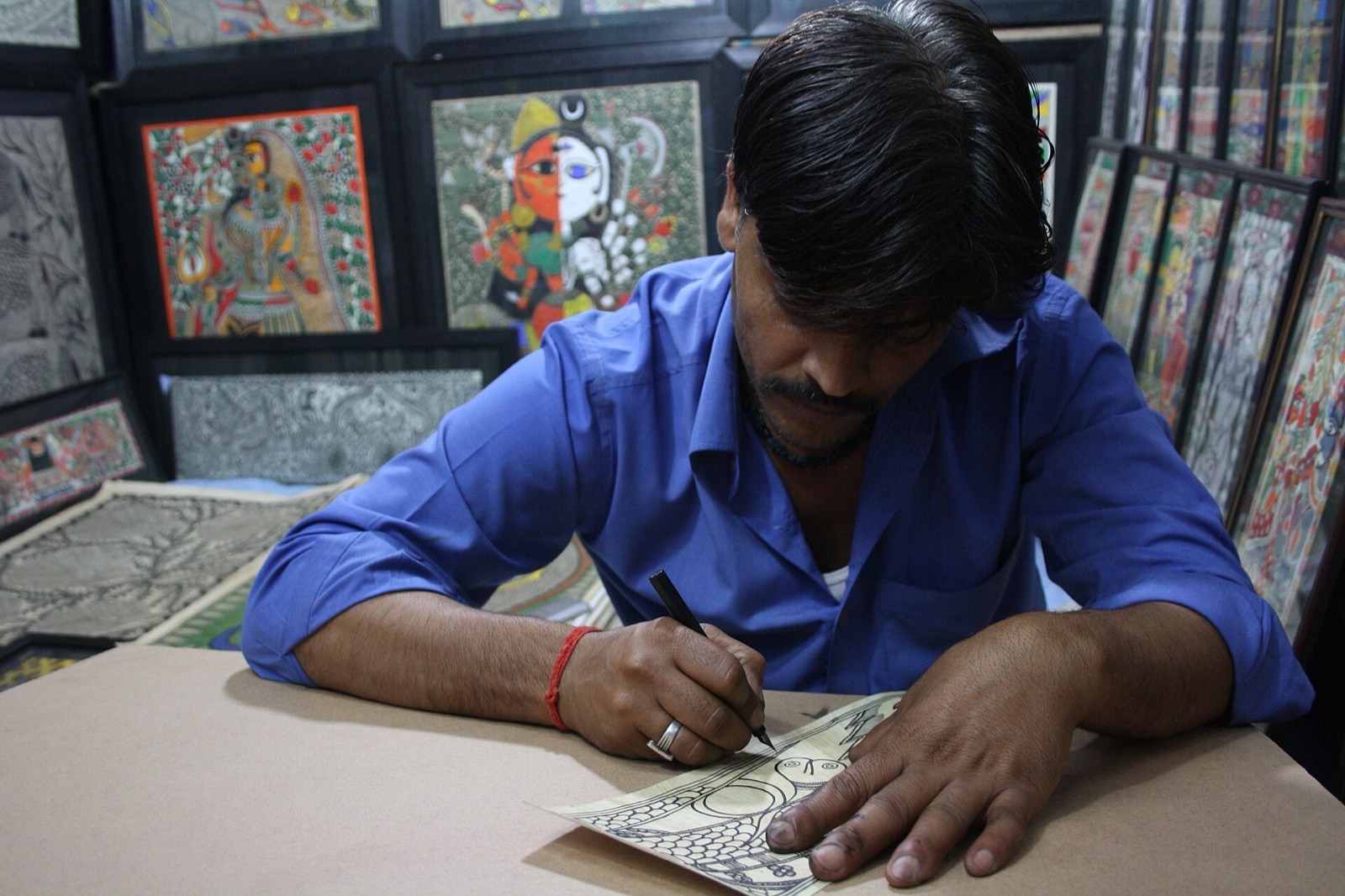 Artist drawing Madhubani painting, a craft of Bihar